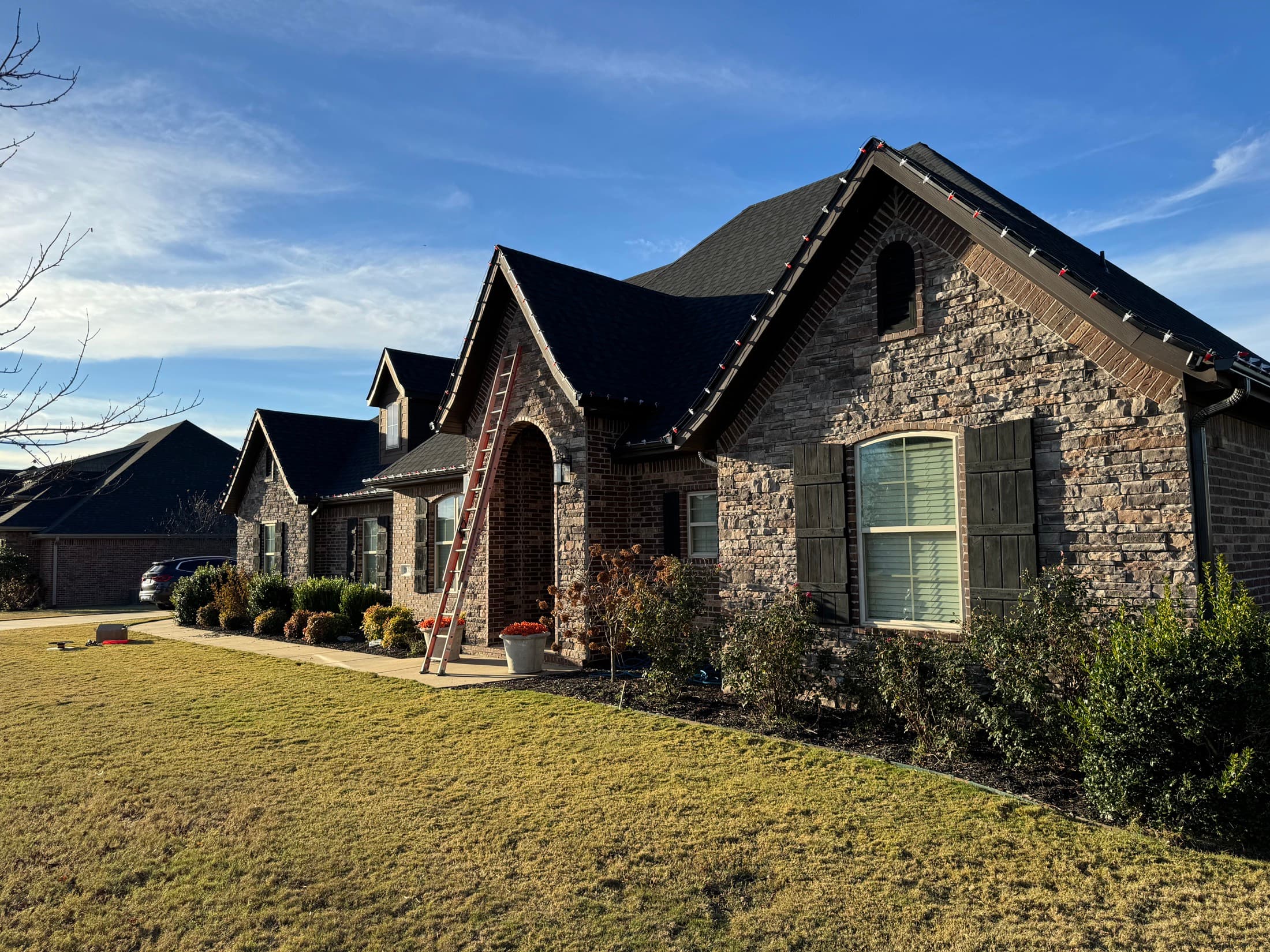 Daytime view of professional holiday light installation along architectural peaks